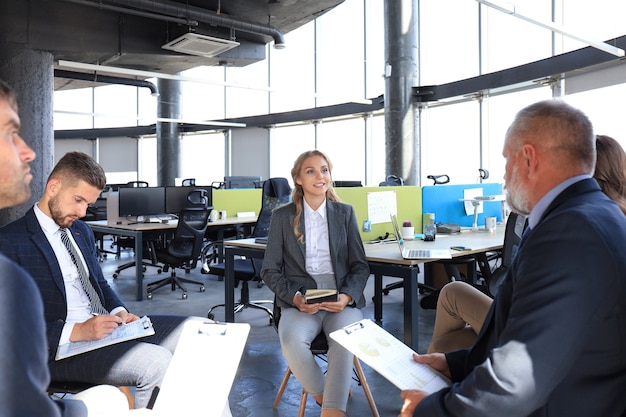 Business team discussing together business plans in office.