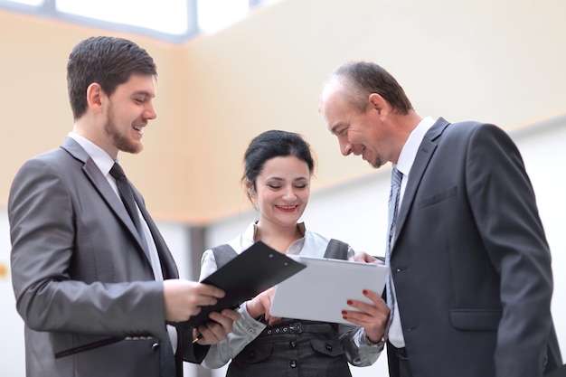 Business team discussing work issues standing in the office