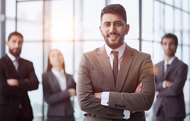 Business team friendly group of four coworkers posing at office standing close together