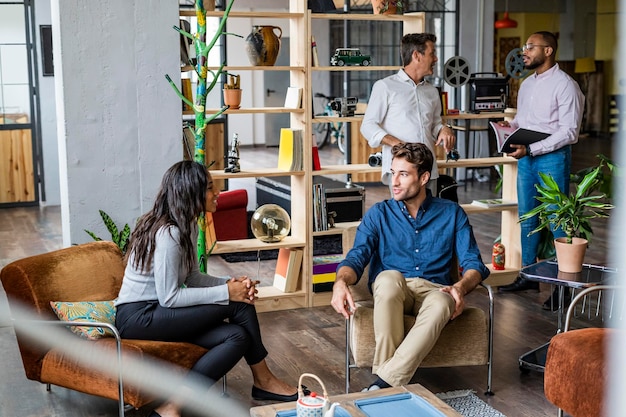 Photo business team having an informal meeting in loft office