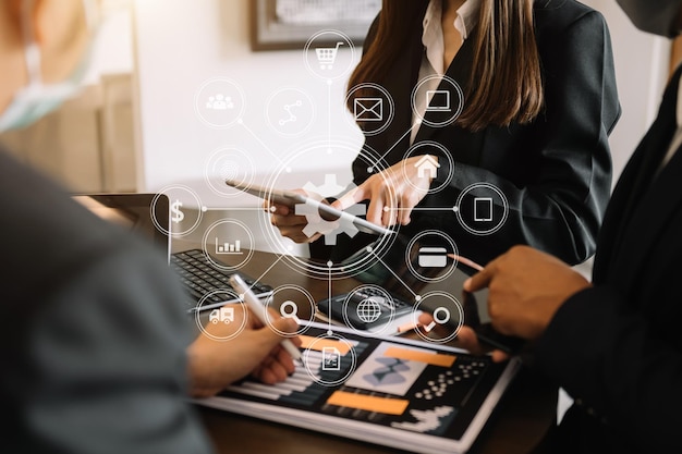 Business team partnership meeting hand using laptop tablet and smartphone in office in VR icon xA