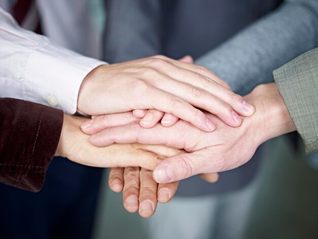 Photo business team putting hands together to show unity