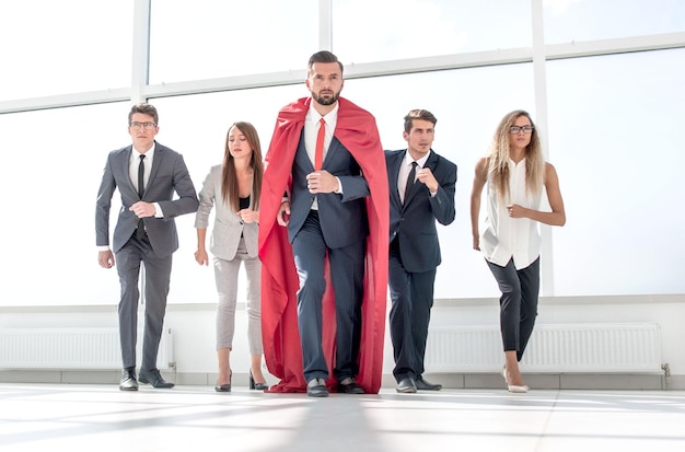 Business team and their leader are marching in the office lobby