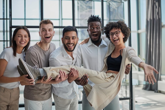 Business team throwing his colleague in office