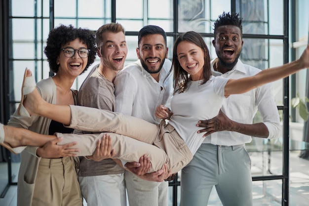 Business team throwing his colleague in office