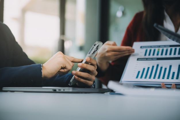 Business team working with new startup project plan and discussion information for financial strategy with laptop and digital tablet in a modern business lounge