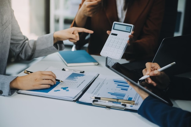 Business team working with new startup project plan and discussion information for financial strategy with laptop and digital tablet in a modern business lounge