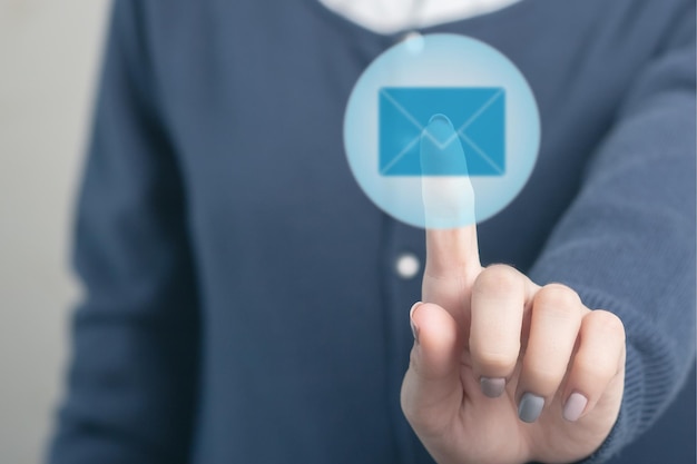 Business technology concept female hands pressing mail icon