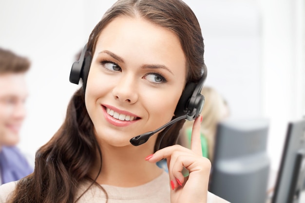 business and technology concept - helpline operator with headphones in call centre