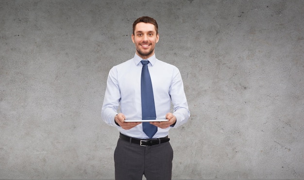 business, technology, internet and education concept - friendly young smiling businesswoman with tablet computer