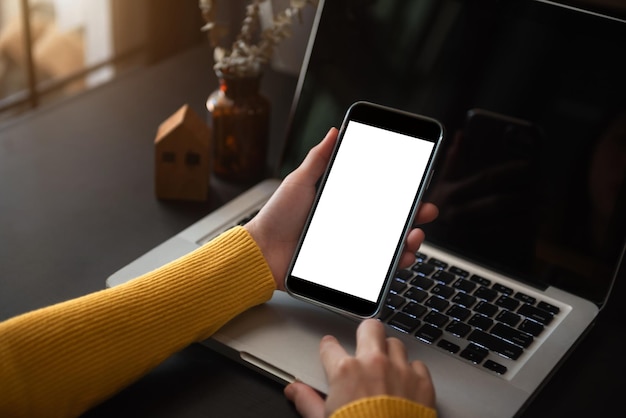 Business technology and office concept Hand holding mobile phone with blank screen in office