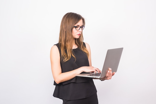 Business, technology and people concept - businesswoman with laptop on white background.