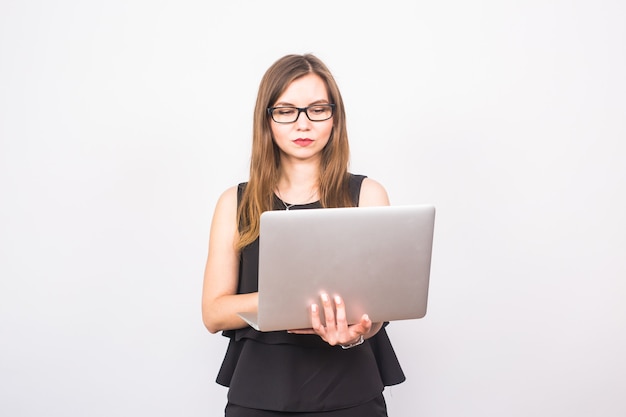 Business, technology and people concept - businesswoman with laptop on white background.