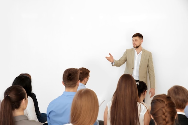 Business trainer giving presentation to group of people