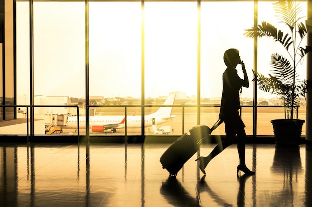 Business woman at Airport - Silhouette of a passenger