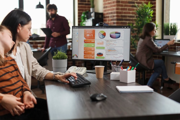 Business woman analyzing economic growth of company and reviews financial and management chart. Finance agency employee reviewing project development while little daughter sits in her lap.