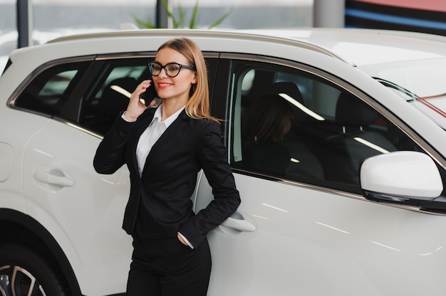 Business woman in auto salon concept of female driver