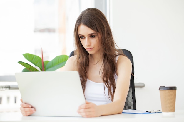 Business woman busy working on laptop computer at office