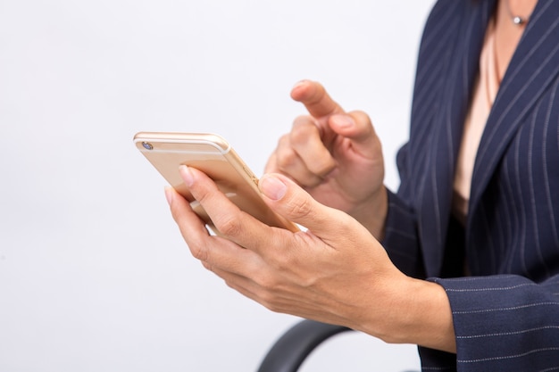 Business woman checks her emails on her mobile cell phone device smartphone