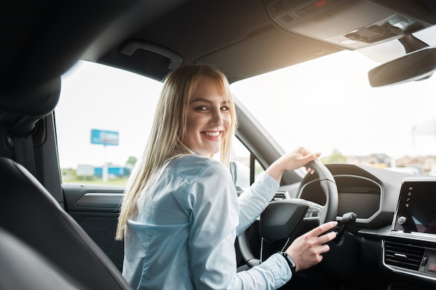 Business woman driving a modern car