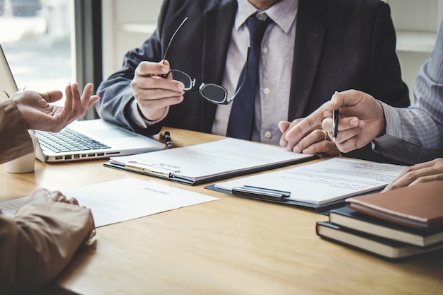 Business woman explaining about profile to two selection committee sitting in during job Interview