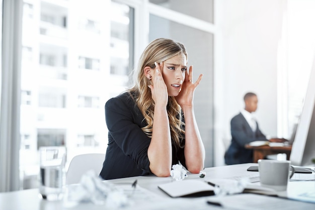 Business woman and frustrated with headache in office from stress overworked and mistake for work deadline Professional employee and migraine at desk with fatigue burnout or anxiety for workload