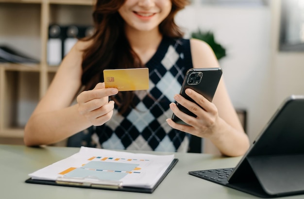 Business woman hands using smartphone and holding credit card as Online shopping xA