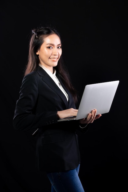 Business woman hold notebook computer and shopping online with internet financial banking Technology help person working communicate every where on mobile phone or laptop black background