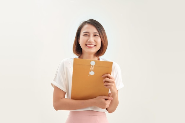 business woman holding brown paper envelopes in office