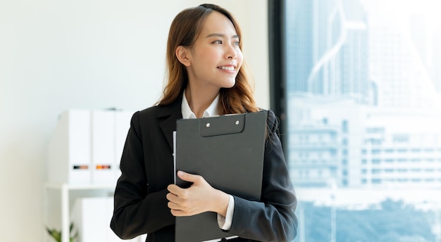 Business woman holding files Inside the modern office