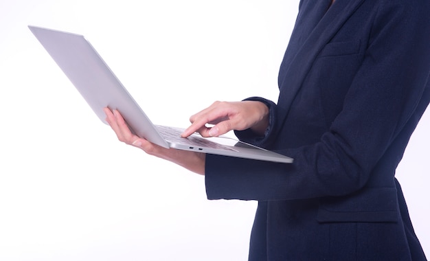 Business woman holding a laptop isolated on white