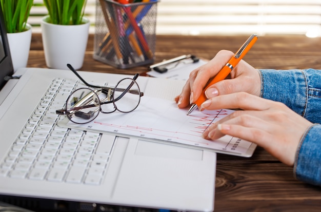 Business woman is working with business documents in the office.