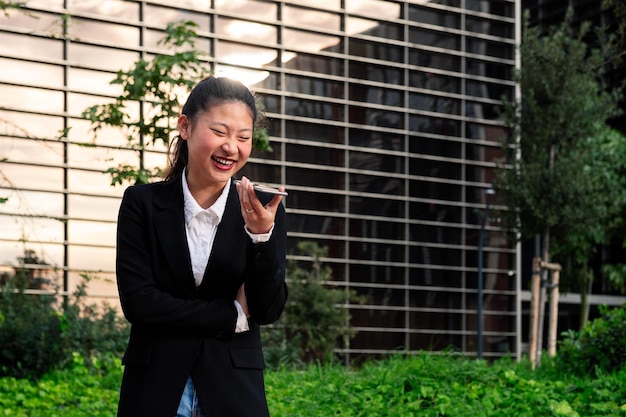 Business woman laughing talking by phone in a park