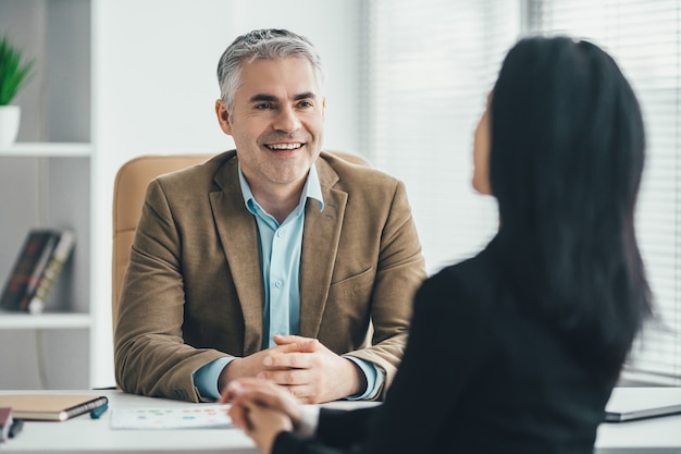 The business woman and a man discussing at the office table