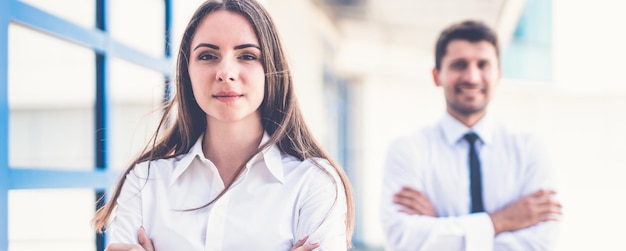 The business woman and man stand near the window