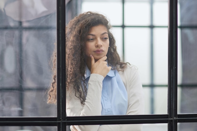 Business woman in the office outside the window