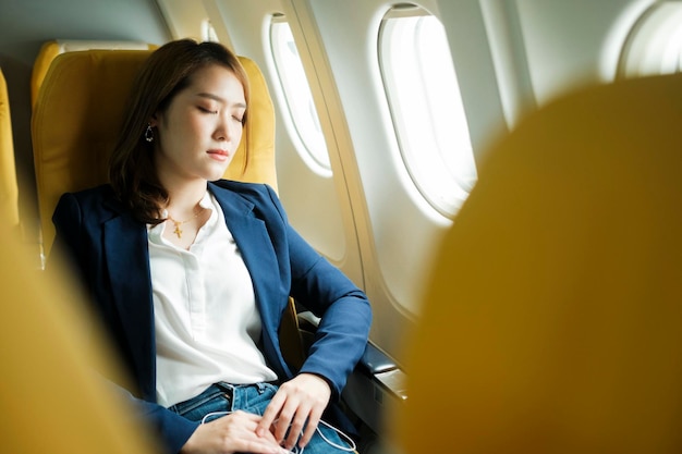 Business woman In a plane sleeping on the plane on the go