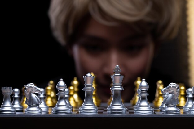 Business woman play Chess with close up Hand Leader use strategy game to challenge competitor with intelligence leadership to move King to victory with management team idea fight copy space