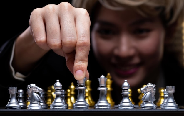 Business woman play Chess with close up Hand Leader use strategy game to challenge competitor with intelligence leadership to move King to victory with management team idea fight copy space