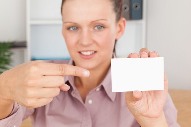 Business woman pointing at a card