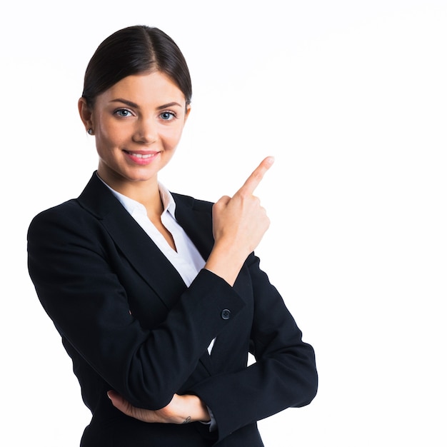 Business woman pointing at copyspace, isolated on white wall