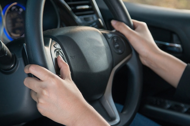 Business woman push a button in modern car.