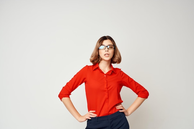 Business woman in red shirt emotions posing light background