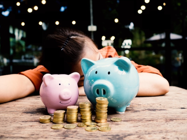 Business woman relaxing behind two piggy bank Saving money for retirement fund concept