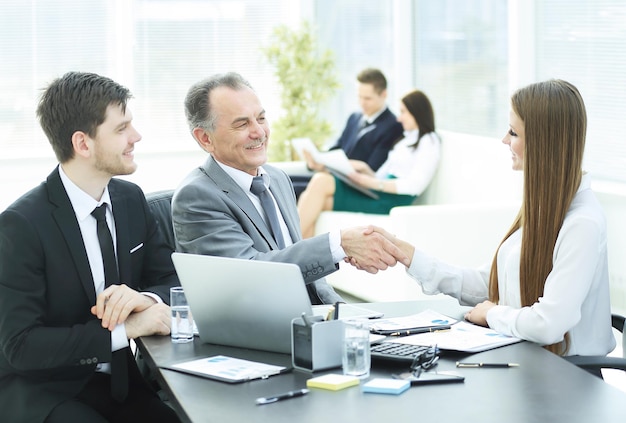 Business woman shaking hands with an adult business partner