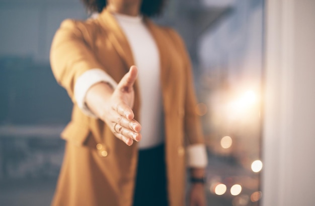 Business woman stretching her hand for a handshake for greeting welcome or partnership in office Company corporate and female employee with shaking hands gesture for agreement in modern workplace