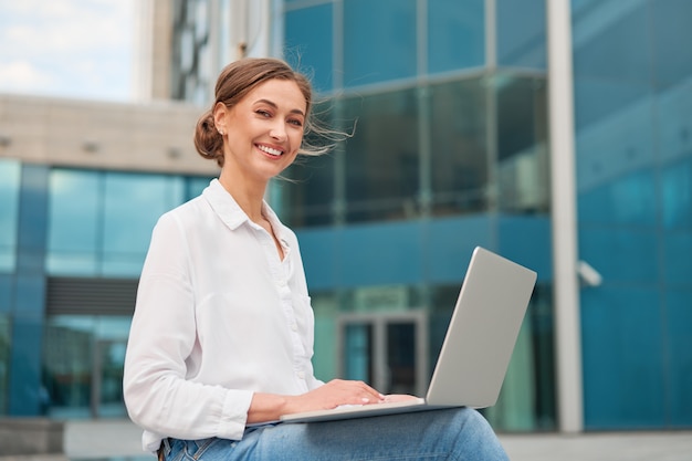 Business woman successful woman business person outdoor with cell laptop