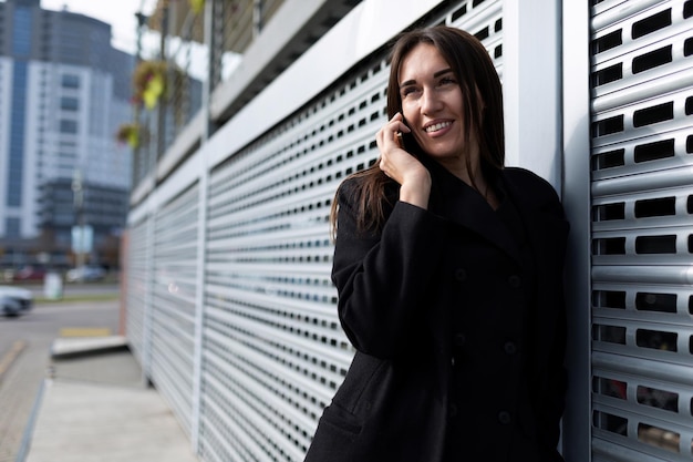 Business woman talking on the corner of the business center on the street