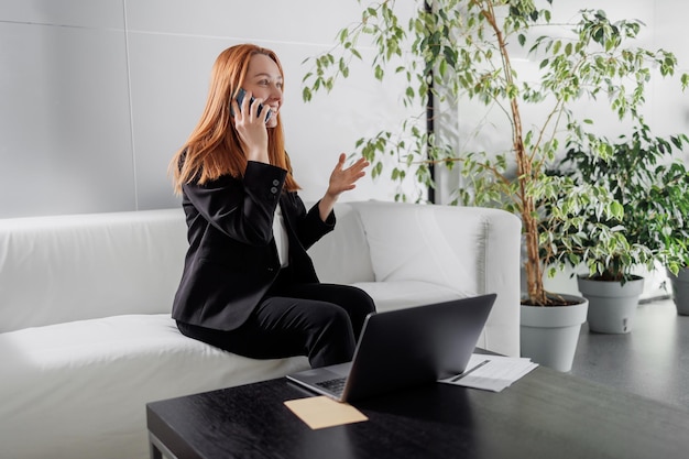 Business woman talking to someone on the phone Happy mid age lady talking to cellphone