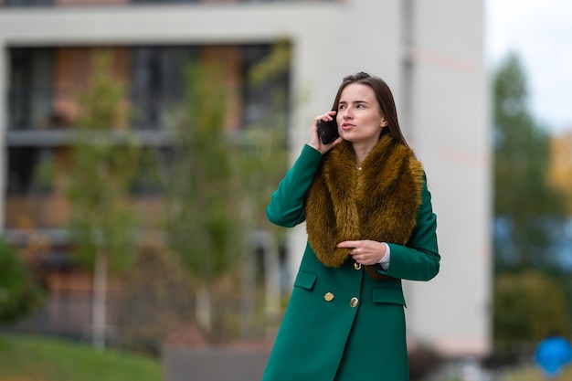 Business woman talking with clients on cell phone in business district